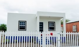Two women the recipients of fully furnished, climate-smart homes in St. Kitts